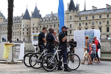 Members of the Paris VTT brigade of the DPP (Direction of the prevention and the protection) patrol along the banks of the Seine during the opening day of the Paris Plages beach festival in Paris, France, six days after a truck driver killed 84 people when he mowed through a crowd on the French Riviera, July 20, 2016. REUTERS/Charles Platiau