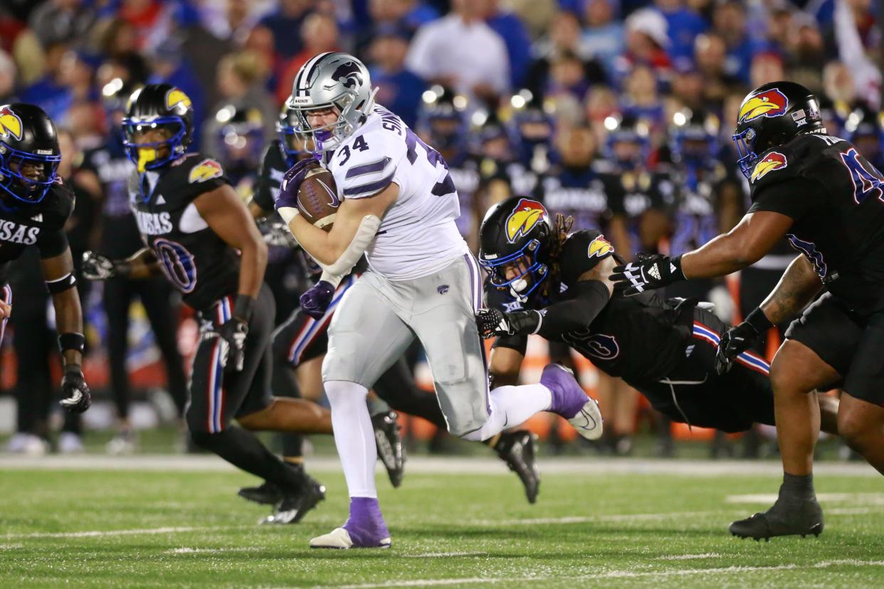 Kansas State tight end Ben Sinnott (34) runs through Kansas' defense during last year's Sunflower Showdown in Lawrence. Sinnott was picked by the Washington Commanders on Friday in the second round of the 2024 NFL Draft.