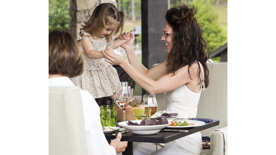 Family lunch outdoors at the Tavern, one of five restaurants at the resort. - Credit: Ball & Albanese