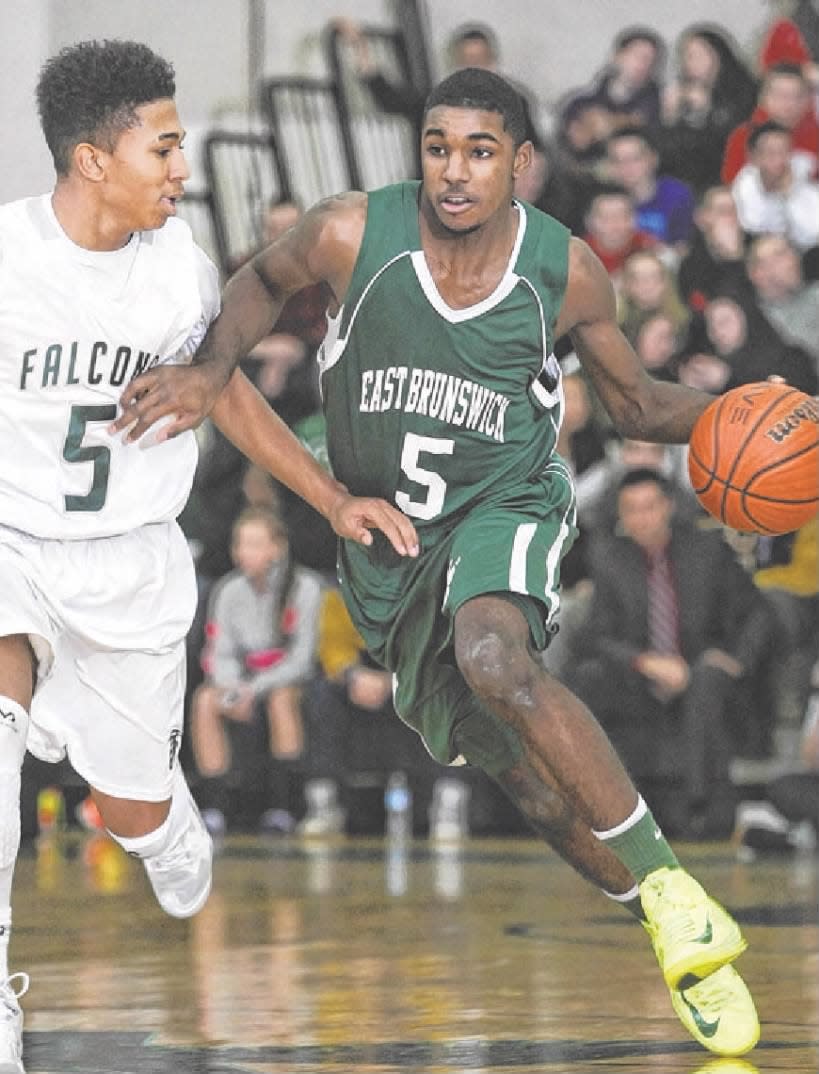 East Brunswick’s Amir Bell drives on St. Joseph’s Breein Tyree during the first half on Thursday, Jan. 23, 2014.