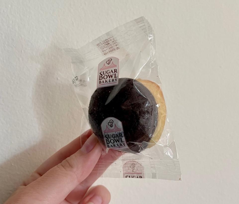 Writer holding a packaged chocolate-covered bite