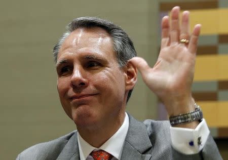 Scott Price, president and chief executive of Wal-Mart Asia gestures at a news conference in Beijing, October 24, 2013. REUTERS/Kim Kyung-Hoon