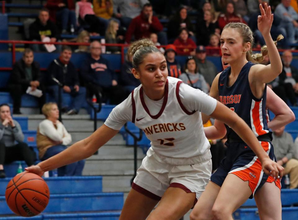 McCutcheon Mavericks Lillie Graves (12) drives past Harrison Raiders Kiersten Guyer (33) during the IHSAA girl’s basketball sectional championship game, Saturday, Feb. 3, 2024, at Kokomo Memorial Gymnasium in Kokomo, Ind.