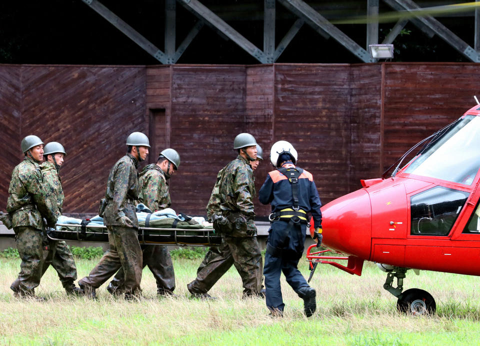 <p>A survivor is taken to a hospital by a helicopter as torrential rain hit on July 6, 2017 in Toho, Fukuoka, Japan. (Photo: The Asahi Shimbun via Getty Images) </p>