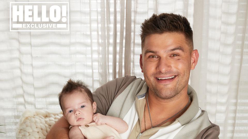 Aljaz Skorjanec wears jumper as he cradles baby Lyra