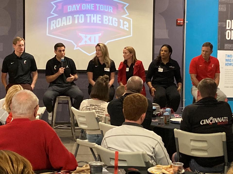 UC coaches speak at the Bearcats Big 12 rally in Columbus May 18. From left are AD John Cunningham, men&#39;s basketball coach Wes Miller, swimming/diving coach Mandy Commons-DiSalle, volleyball coach Molly Alvey, women&#39;s basketball coach Katrina Merriweather and football coach Scott Satterfield.