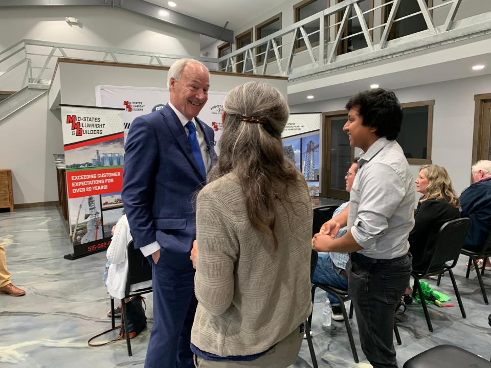 In his latest visit to Iowa, Republican presidential candidate Asa Hutchinson speaks to Roberto and Karen Dubiel during a town hall with the Story County GOP at Mid-States Companies on Thursday, June 1, 2023.