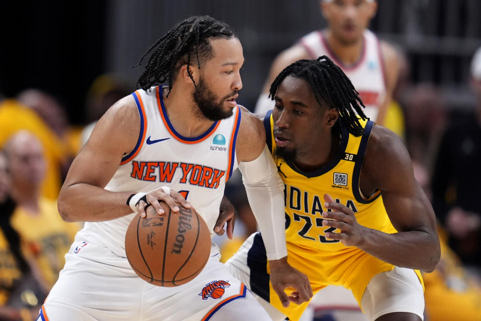 New York Knicks guard Jalen Brunson drives around Indiana Pacers forward Aaron Nesmith (23) during the second half of Game 3 in an NBA basketball second-round playoff series, Friday, May 10, 2024, in Indianapolis. (AP Photo/Michael Conroy)