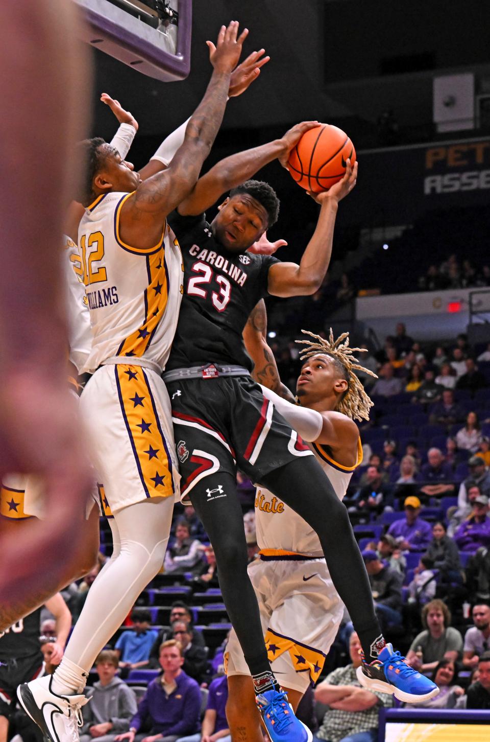 South Carolina forward Gregory "GG" Jackson II (23) gets jammed up under the basket by LSU forward KJ Williams (12) and guard Adam Miller (44) during an NCAA college basketball game, Saturday, Feb. 18, 2023, in Baton Rouge, La. (Hilary Scheinuk/The Advocate via AP)