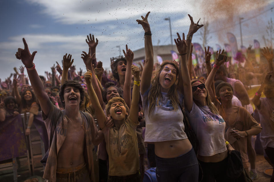 <p>Revelers, covered in colored powder celebrate at a Holi Run festival in Madrid, April 12, 2015. (AP Photo/Andres Kudacki) </p>