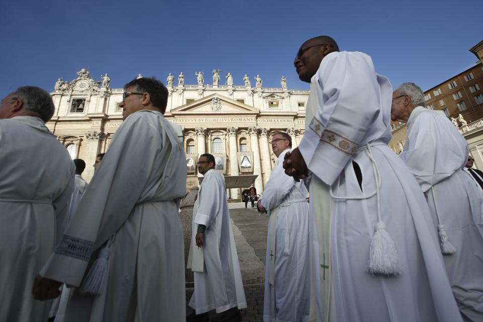 Priests arrive to attend a canonization Mass in St. Peter's Square at the Vatican, Sunday, Oct. 13, 2019. Pope Francis canonizes Cardinal John Henry Newman, the 19th century Anglican convert who became an immensely influential thinker in both Anglican and Catholic churches, and four other women. (AP Photo/Alessandra Tarantino)