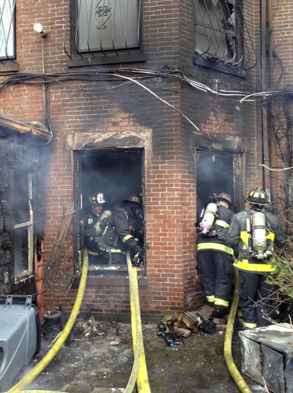 In this photo released by the Boston Fire Department via Twitter, firefighters battle a multi-alarm fire at a four-story brownstone in the Back Bay neighborhood near the Charles River Wednesday, March 26, 2014 in Boston. (AP Photo/Boston Fire Department)