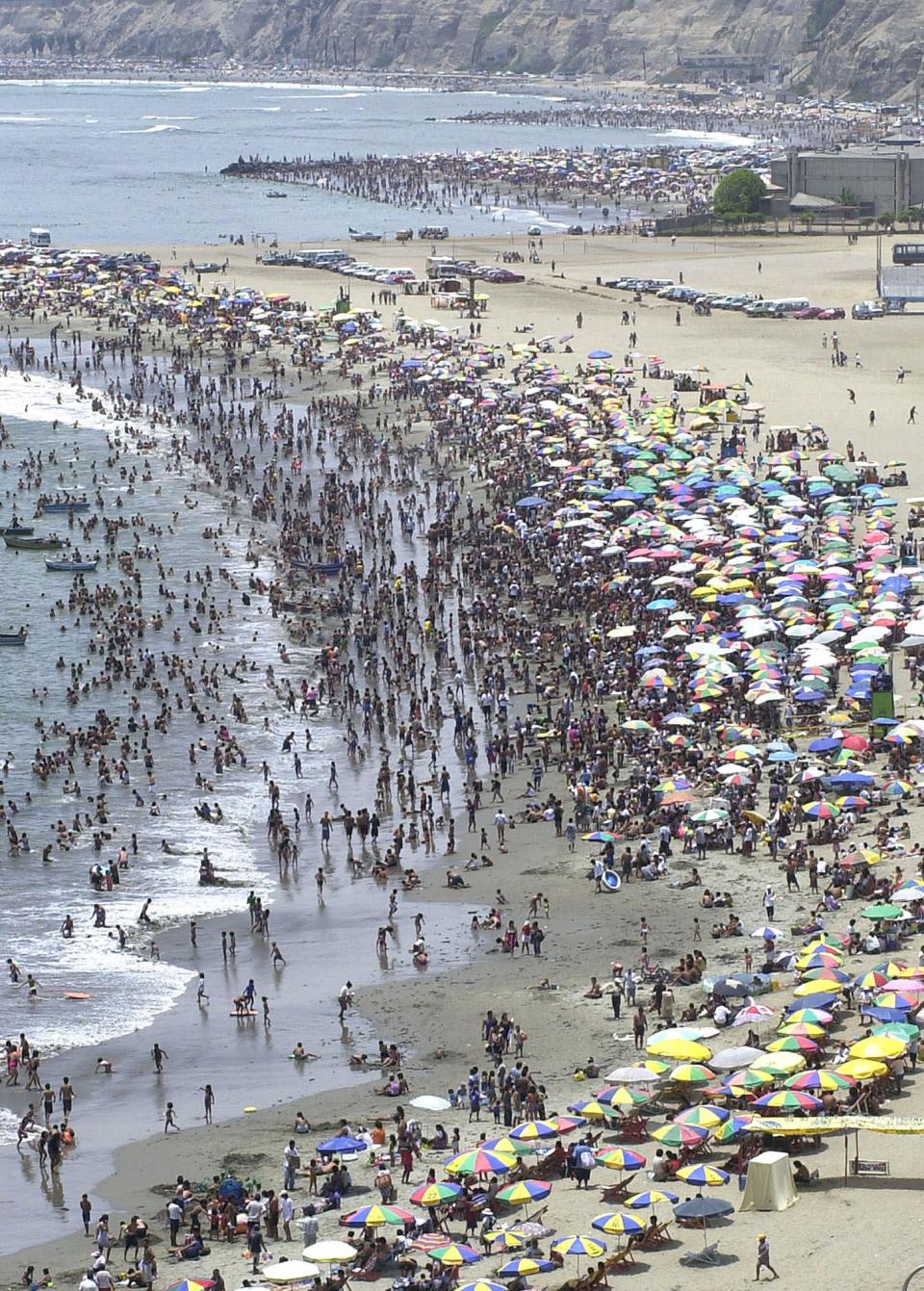 FILE - This Feb. 25, 2001 file photo shows beachgoers enjoying the warm weather on the Pacific Ocean coast in Lima, Peru. But there are plenty of things to do and see around Lima for free, from parks to plazas, starting with the Pacific Ocean. (AP Photo/Martin Mejia, file)