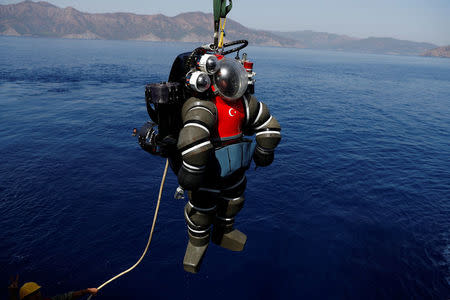 A Turkish Navy diver in an atmosphere diving suit (ADS) surfaces after a dive on board the Turkish Navy's submarine rescue mother ship TCG Alemdar during the Dynamic Monarch-17, a NATO-sponsored submarine escape and rescue exercise, off the Turkish Naval base of Aksaz, Turkey, September 20, 2017. Picture taken September 20, 2017. REUTERS/Murad Sezer