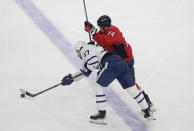 Toronto Maple Leafs' Timothy Liljegren, left, is defended by Washington Capitals' Connor McMichael (24) during the second period of an NHL hockey game Monday, Feb. 28, 2022, in Washington. (AP Photo/Luis M. Alvarez)