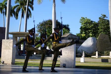 Guards march near a granite boulder where Cuba's former President Fidel Castro's ashes were encased during a private ceremony at the Santa Ifigenia Cemetery, in Santiago de Cuba, December 4, 2016. REUTERS/Ivan Alvarado