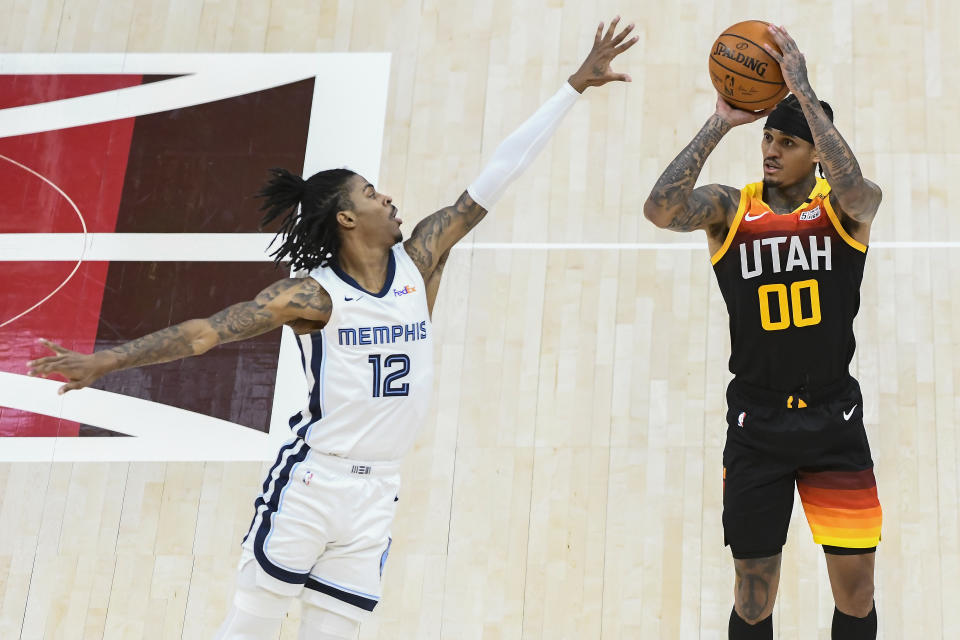 Utah Jazz guard Jordan Clarkson shoots over Memphis Grizzlies guard Ja Morant in the Jazz's Game 5 win of their Western Conference first-round playoff series at Vivint Arena in Salt Lake City on June 2, 2021. (Alex Goodlett/Getty Images)