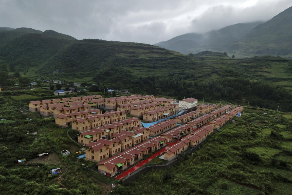 An aerial view shows new village houses built by the Chinese government for ethnic minority in Ganluo county, southwest China's Sichuan province on Sept. 10, 2020. China's ruling Communist Party says its initiatives have helped to lift millions of people out of poverty. Yi ethnic minority members were moved out of their mountain villages in China’s southwest and into the newly built town in an anti-poverty initiative. (AP Photo/Sam McNeil)