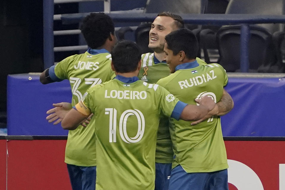 Seattle Sounders' Jordan Morris, back right, celebrates with teammates after he scored his first goal of the first half of the team's MLS soccer match against the San Jose Earthquakes, Thursday, Sept. 10, 2020, in Seattle. (AP Photo/Ted S. Warren)