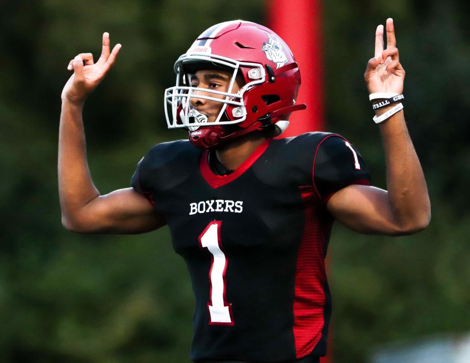 Brockton's Cameron Monteiro signals for a two-point conversion during a game against Natick at Marciano Stadium on Friday, Sept. 30, 2022. Brockton won 52-17.