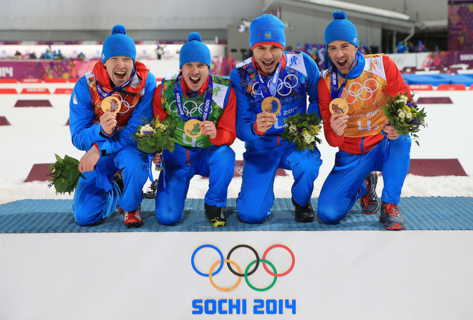 SOCHI, RUSSIA - FEBRUARY 22:  (L-R) Alexey Volkov, Evgeny Ustyugov, Dmitry Malyshko and Anton Shipulin of Russia celebrate on the podium during flower ceremony for the Men's 4 x 7.5 km Relay during day 15 of the Sochi 2014 Winter Olympics at Laura Cross-country Ski & Biathlon Center on February 22, 2014 in Sochi, Russia.  (Photo by Richard Heathcote/Getty Images)