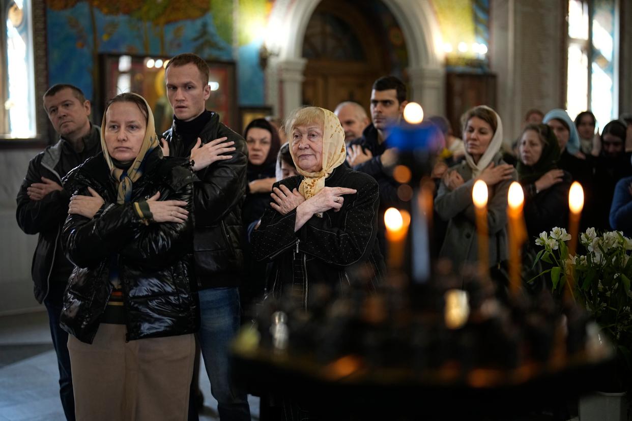 Parishioners wait for communion after the religion service in preparation for an Easter celebration service during the Great Holy Saturday at the Church of the Annunciation of the Holy Virgin in Sokolniki in Moscow, Russia (Copyright 2023 The Associated Press. All rights reserved)
