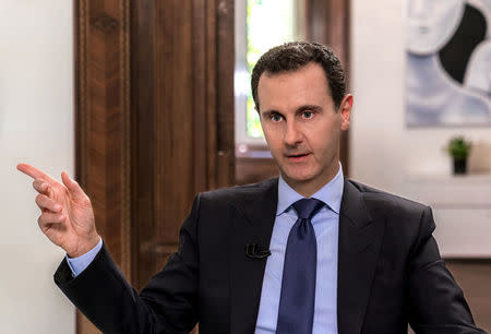 Syrian President Bashar al-Assad speaks during an interview with Russian television channel NTV, in Damascus, Syria in this handout released on June 24, 2018. SANA/Handout via REUTERS