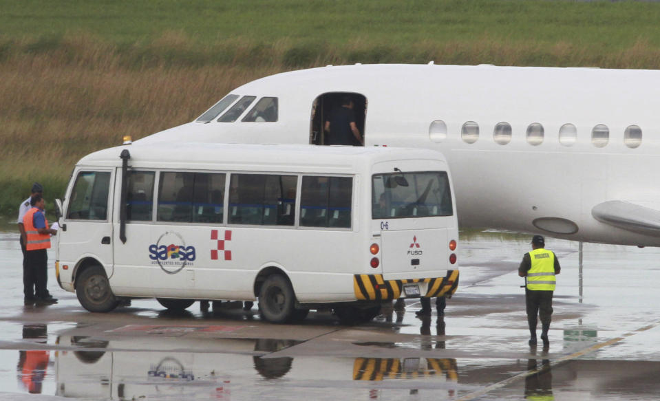 A man who appears to be Italian fugitive Cesare Battisti enters the cabin door of a plane before it takes off for Italy, where he will serve a life sentence, at the airport in Santa Cruz, Bolivia, Sunday, Jan. 13, 2019. Battisti escaped from an Italian prison in 1981 while awaiting trial on four counts of murder allegedly committed when he was a member of the Armed Proletarians for Communism. (AP Photo)