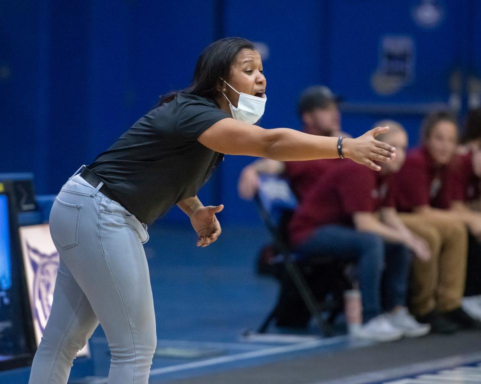 Wildcats head coach Jade Brown shouts to her team on the floor during the Navarre vs Washington girls basketball game at Booker T. Washington High School in Pensacola on Wednesday, Nov. 17, 2021.