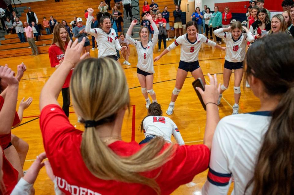 The Hancock Hawks volleyball team celebrates after winning the 6A South State Championship game at Hancock High School in Kiln on Monday, Oct. 16, 2023.