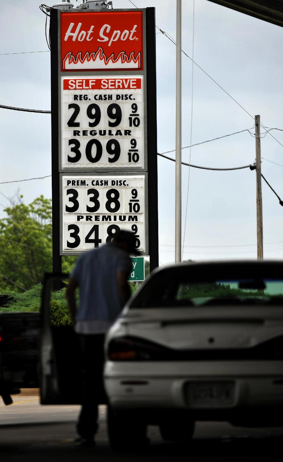 A motorist gets gas at a Hot Spot convenience store on East Main St. where the price is $2.99 a gallon, Friday, June 1, 2012 in Spartanburg, S.C. Oil prices plunged Friday as bleak reports on U.S. job growth and manufacturing heightened worries about a slowing global economy. (AP Photo/Rainier Ehrhardt)