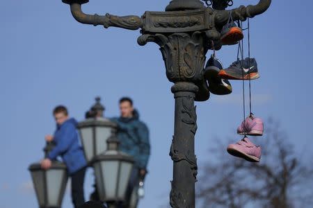 FILE PHOTO: Shoes hung on a lamp post by opposition supporters are pictured after a rally in Moscow, Russia March 26, 2017. REUTERS/Maxim Shemetov/File Photo