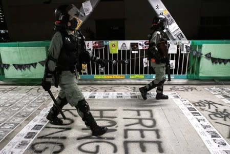 Riot police officers patrol during a protest at Tseung Kwan O district, in Hong Kong