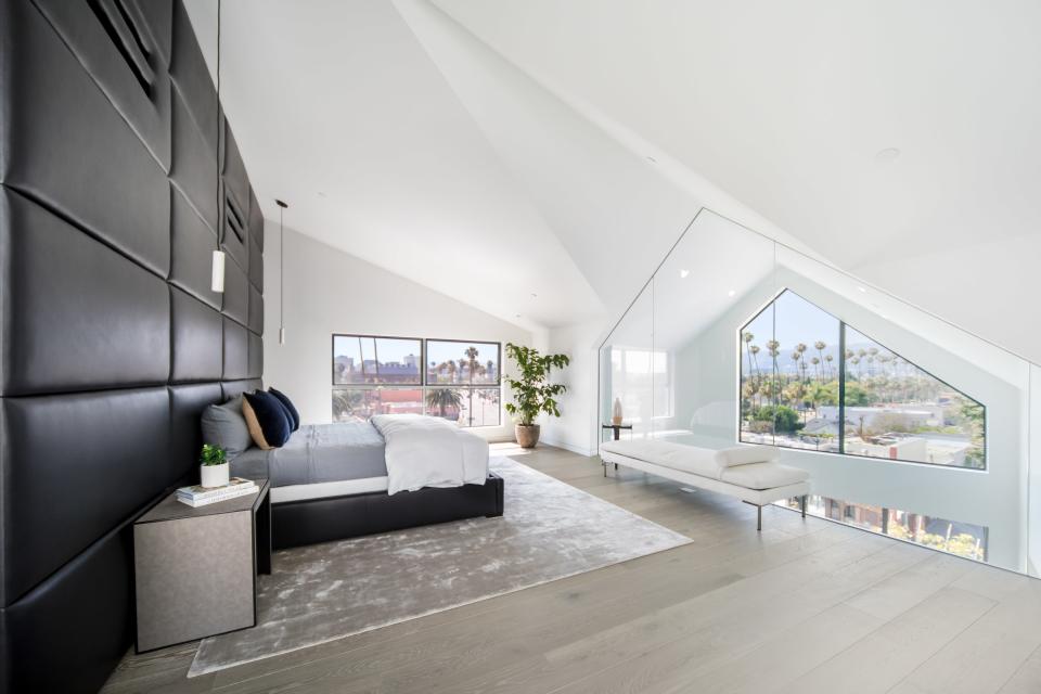 A view inside a master bedroom, with views of Beverly Hills in the distance.