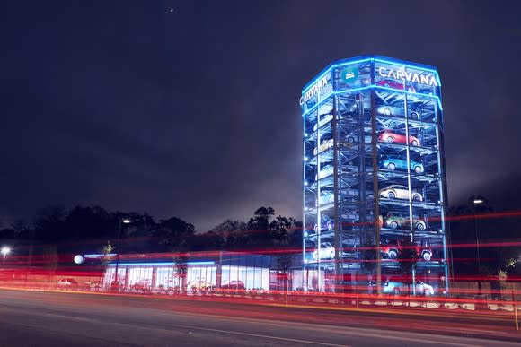 Carvana's vending machine at night, lit up and filled with cars.