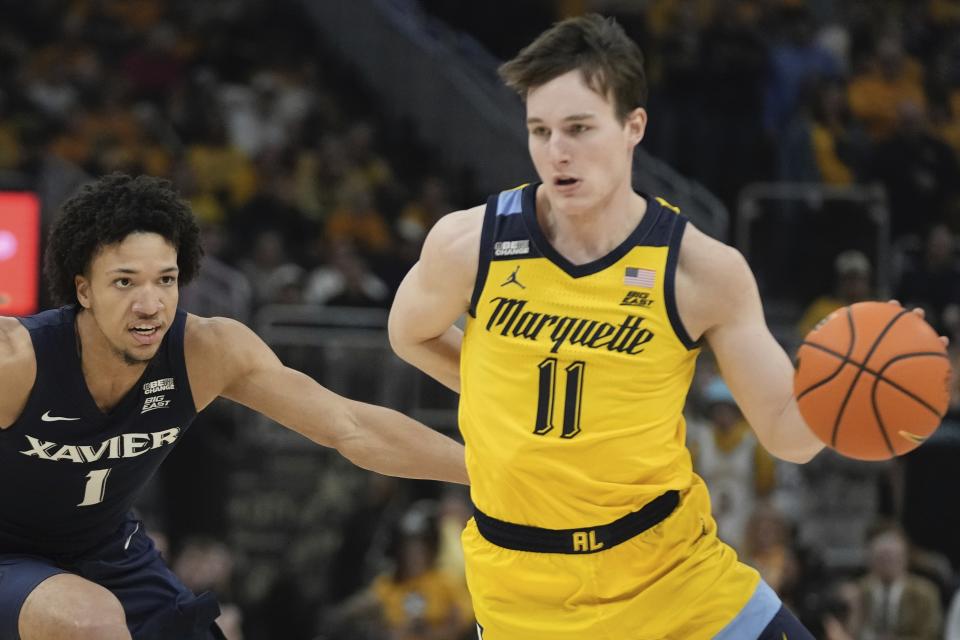 Marquette's Tyler Kolek drives past Xavier's Desmond Claude during the first half of an NCAA college basketball game Sunday, Feb. 25, 2024, in Milwaukee. (AP Photo/Morry Gash)