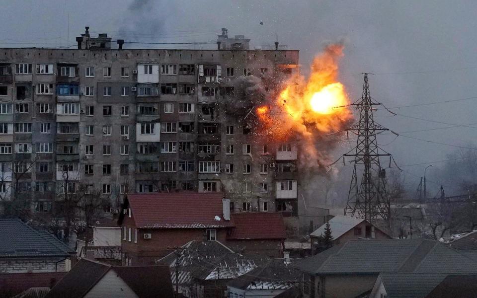 An apartment building is hit in the battle for Mariupol