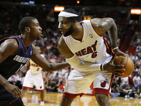 Mar 3, 2014; Miami, FL, USA; Miami Heat small forward LeBron James (6) dribbles the ball past Charlotte Bobcats small forward Michael Kidd-Gilchrist (14) in the second half at American Airlines Arena. Robert Mayer-USA TODAY Sports