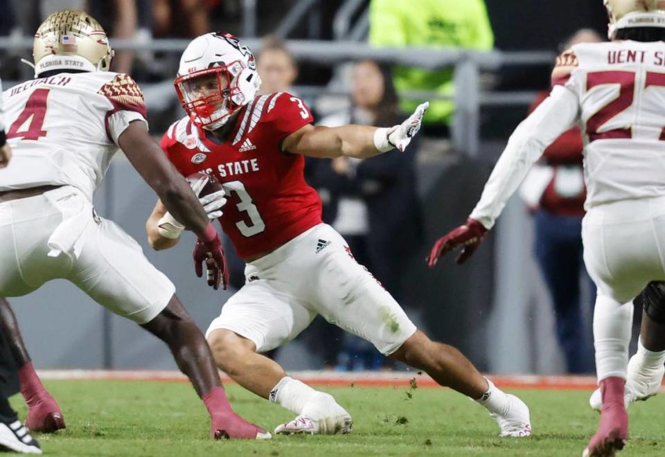 N.C. State running back Jordan Houston (3) cuts to make Florida State wide receiver Mycah Pittman (4) miss during the first half of N.C. State’s game against Florida State at Carter-Finley Stadium in Raleigh, N.C., Saturday, Oct. 8, 2022.