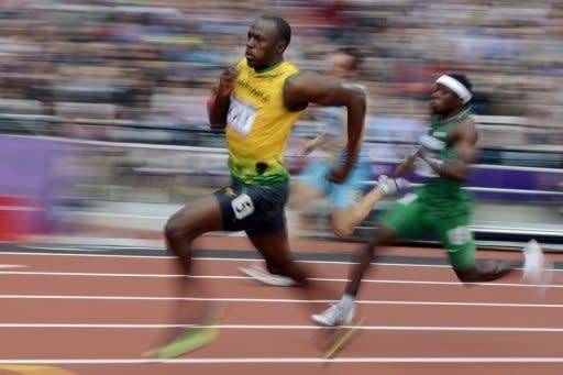 Jamaica's Usain Bolt (L) and Nigeria's Noah Akwu (R) during in the men's 200m heats at the London Olympics on August 7. Bolt, fresh from running the second-fastest time in history to retain his 100m title on Sunday, began his bid to keep his 200m title by winning his heat in 20.39sec