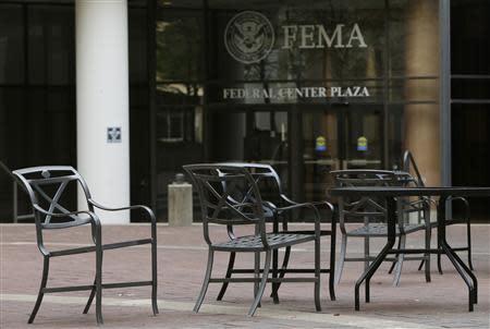 Empty tables and chairs are seen outside the main headquarters of FEMA, which is partially closed, during day three of the U.S. government shutdown in Washington October 3, 2013. REUTERS/Gary Cameron