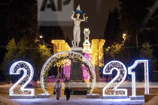 <p>People pass an installation to celebrate New Year in Moscow, Russia</p> (AP)