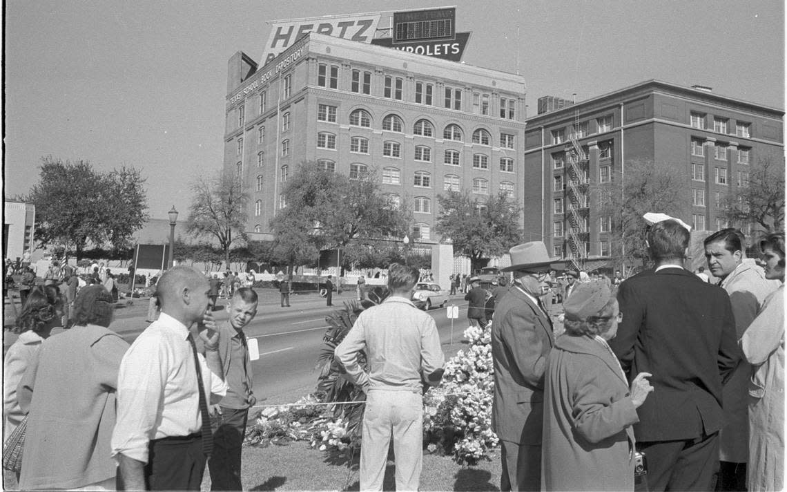 Nov. 23, 1963: Dealey Plaza and the Texas State Book Depository building with crowds on street mourning the assassination of President John F. Kennedy the day after the shooting.