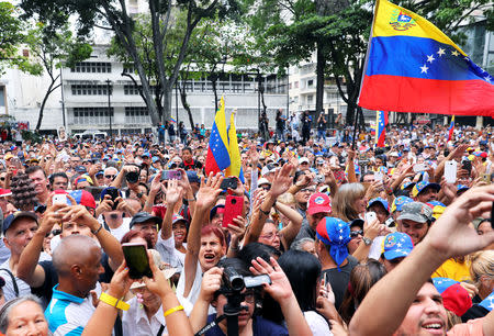 Supporters of Venezuelan opposition leader Juan Guaido, who many nations have recognised as the country's rightful interim ruler, take part in a gathering in Caracas, Venezuela, April 19, 2019. REUTERS/Manaure Quintero