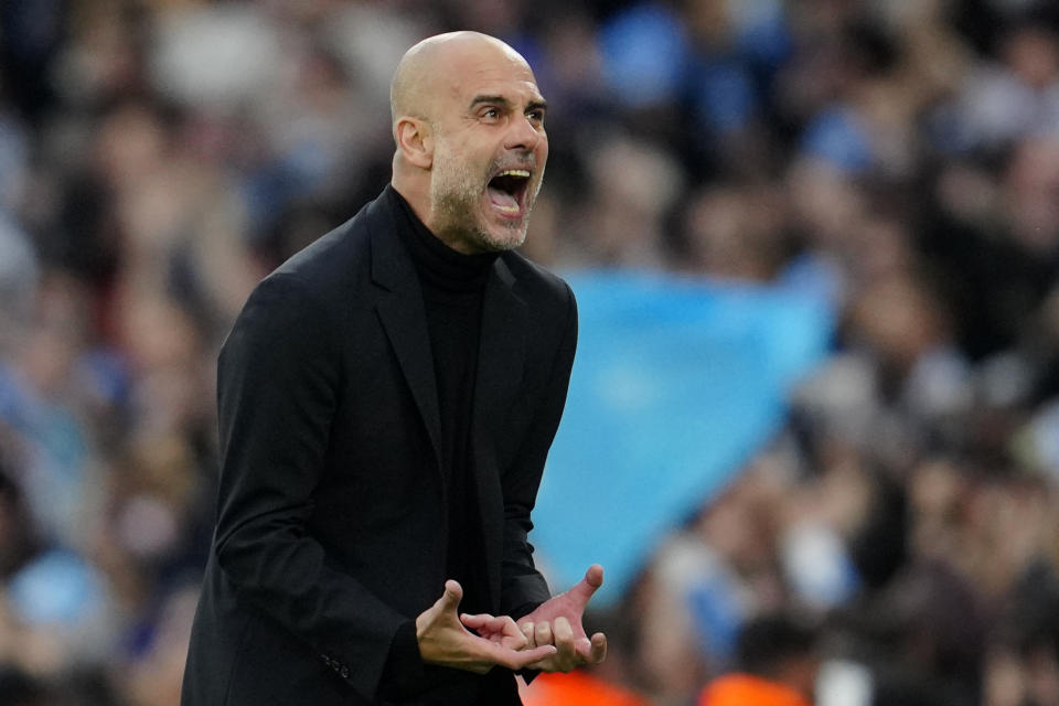 Manchester City's head coach Pep Guardiola reacts after Bernardo Silva scored the opening goal during the Champions League semifinal second leg soccer match between Manchester City and Real Madrid at Etihad stadium in Manchester, England, Wednesday, May 17, 2023. (AP Photo/Jon Super)