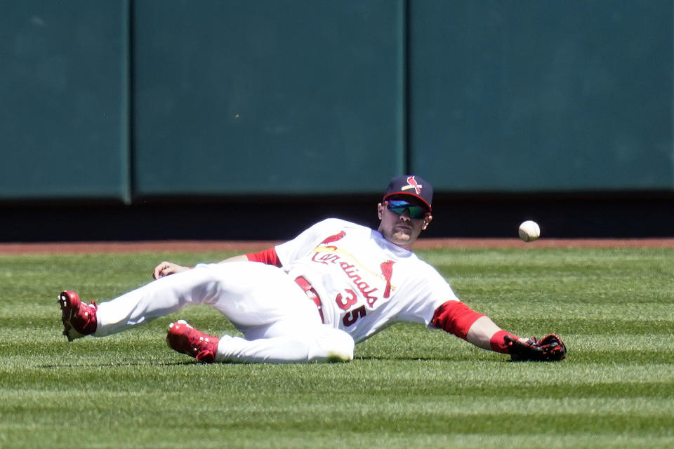 St. Louis Cardinals center fielder Lane Thomas is unable to catch a double by Milwaukee Brewers' Manny Pina during the first inning of a baseball game Sunday, April 11, 2021, in St. Louis. (AP Photo/Jeff Roberson)