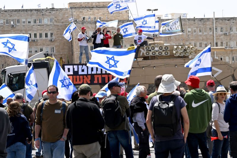 Army reserve activists wave Israeli flags at Tuesday's protest against military exemption for Israel's Ultra-Orthodox citizens outside Prime Minister Benjamin Netanyahu's office in Jerusalem. Photo by Debbie Hill/UPI