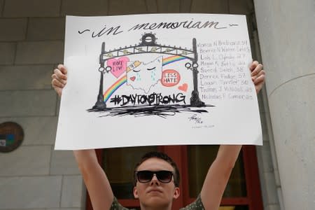 A protester stands in front of city hall in opposition to U.S. President Donald Trump visit to Dayton following a mass shooting in Dayton