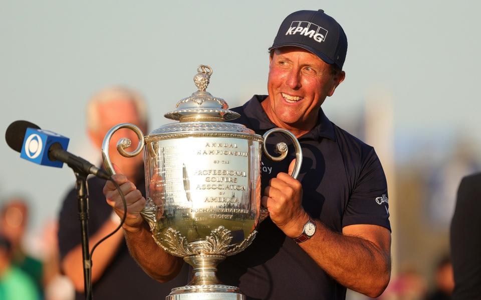 Phil Mickelson of the United States celebrates with the Wanamaker Trophy - Getty Images