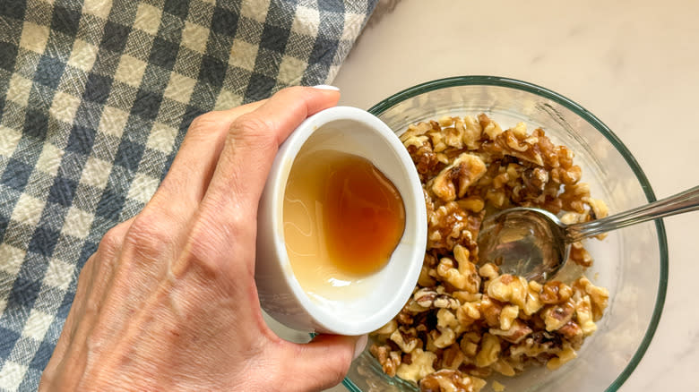 hand pouring syrup in bowl